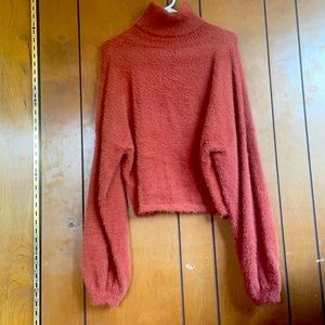 Fuzzy orange turtleneck balloon sleeves